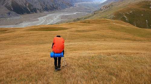 human person walking on mountain field