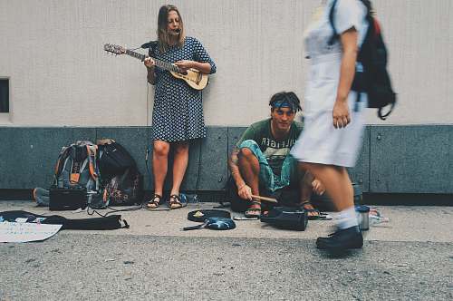 person woman playing guitar on street human
