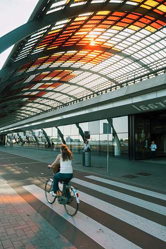 person woman riding beach cruiser bicycle on pedestrian lane human