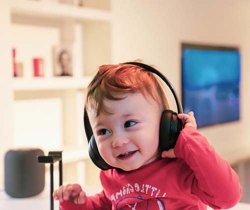 human baby listening in black headset people