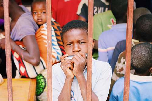 human boy playing harmonica people