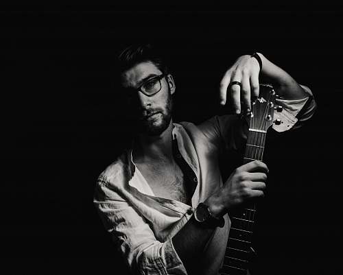 guitar grayscale photo of man holding guitar black-and-white