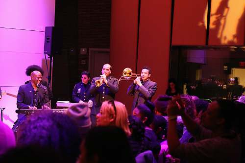 human group of men playing music instruments on stage people