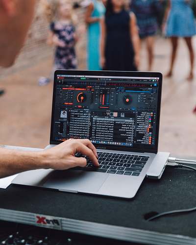 human MacBook Pro displaying DJ mixer pc
