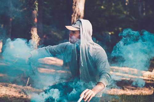 human man doing smoke tricks people