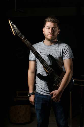 people man holding a electric guitar human