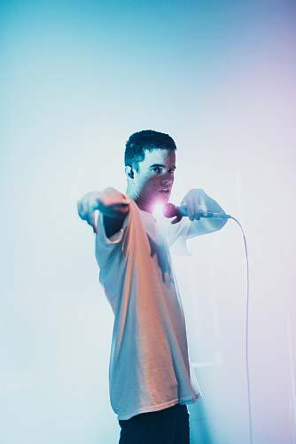 human man holding microphone dance pose