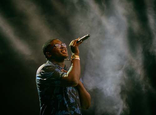 human man holding microphone singing people