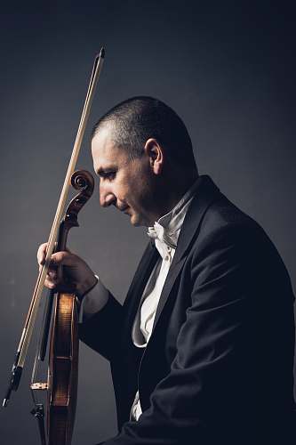 human man holding violin and bow people