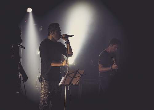 human man in black t-shirt singing musician