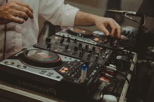 human man operating DJ controller dj