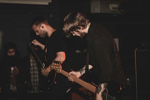 human man playing bass guitar guitar