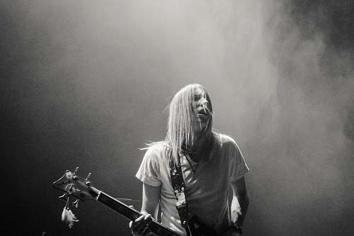 human man playing electric guitar black-and-white