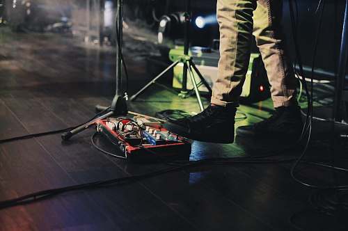 people man playing red musical instrument on stage human