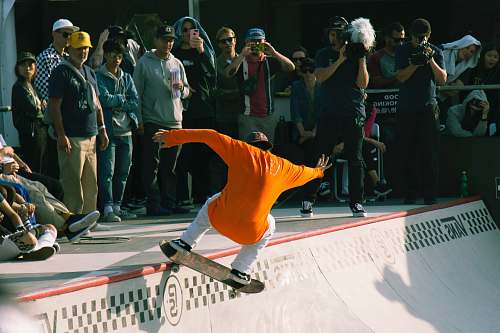human man riding skateboard people
