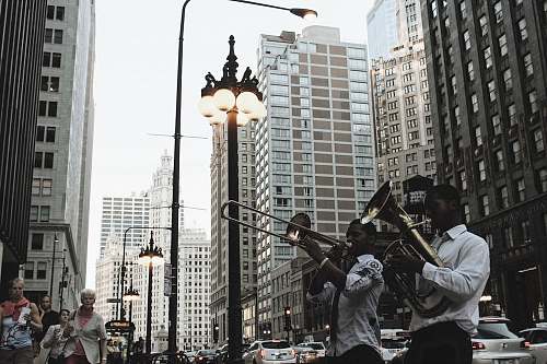 human men's playing instruments on road people