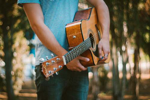 people person holding acoustic guitar human