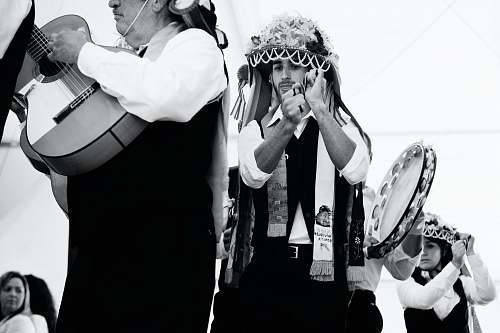 human three person playing musical instrument photo black-and-white