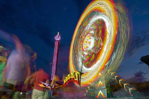 human time-lapse photo of lighted Ferris wheel at park during nighttime people