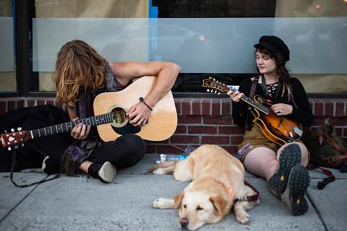 human two men playing guitars people