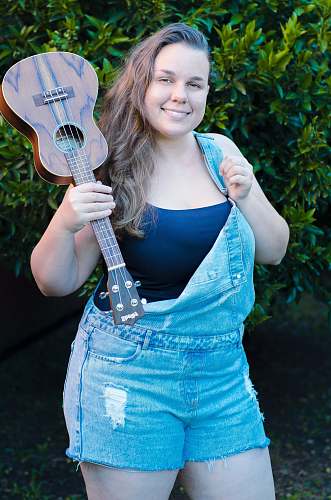 human woman carrying ukulele guitar