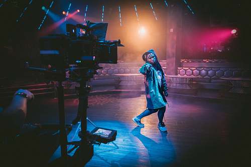 people woman dancing on stage near black cameras human