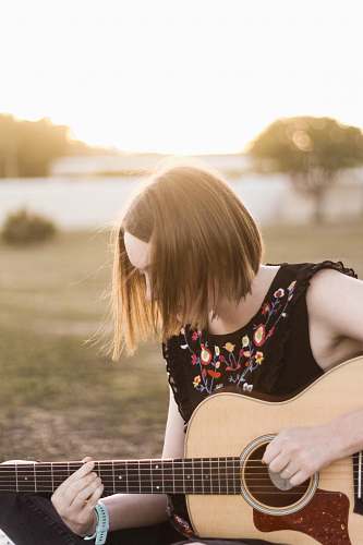 human woman playing acoustic guitar people