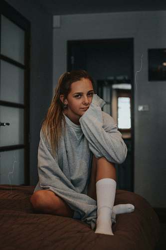 human woman sitting on bed people