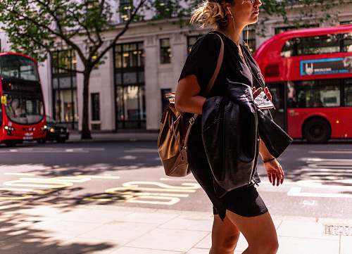 vehicle woman walking on sidewalk bus