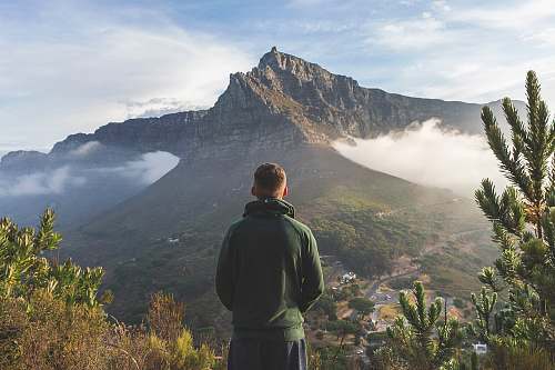  man standing in front of mountain 