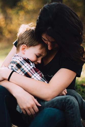  woman hugging boy on her lap 