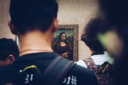 person men in front of Mona Lisa painting people