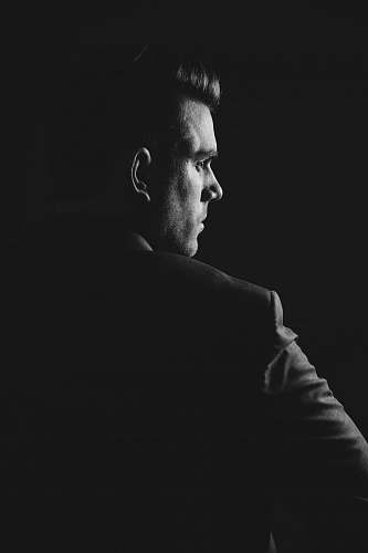 portrait grayscale photo of man wearing blazer person
