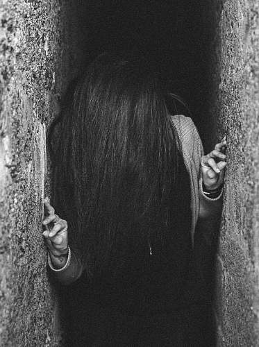 people woman between gray concrete wall person