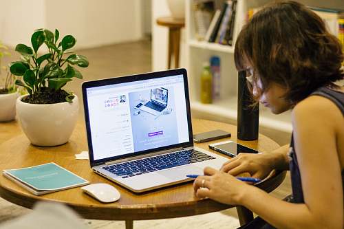 plant woman browsing on her laptop laptop