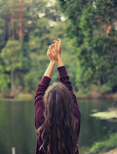 people woman raising both of her hands nature