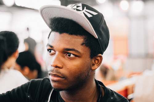 human closeup photo of man wearing black and white cap person