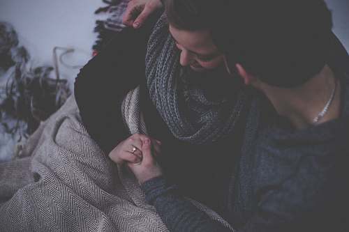 human couple with grey blanket couple