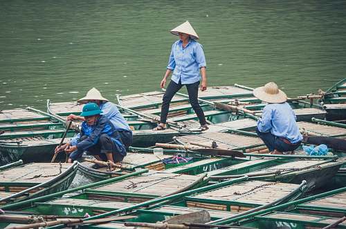 person four men standing on boat during daytime boat