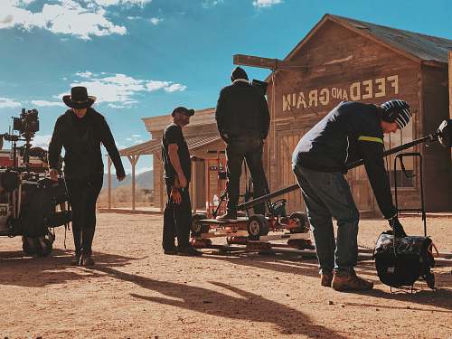 person four men standing outside Feed and Grain store human