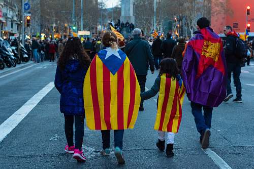 person four person walking on road with flag capes human