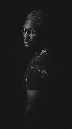 black-and-white grayscale photo of man in eyeglasses black
