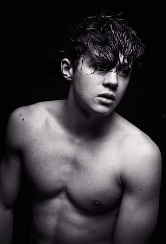 male grayscale photo of topless man man