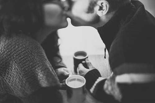 black-and-white grayscale photography of a man kissing a woman grey