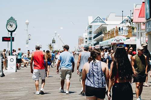 boardwalk group of people walking on street during daytime tourist