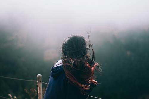 person landscape photography of woman standing in front of trees woman