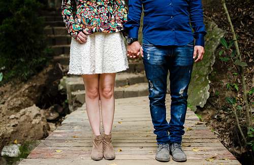 couple man and woman holding hands during daytime clothing