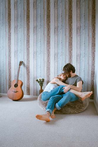 couple man and woman sitting on gray beanbag love