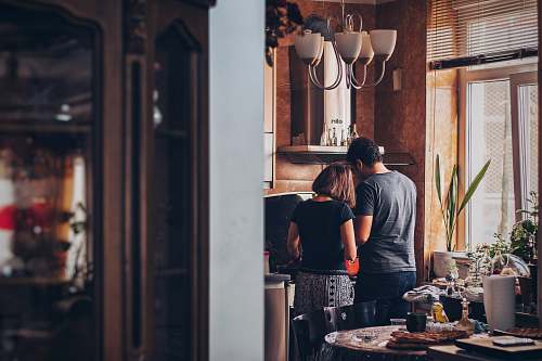 food man and woman standing in front of gas range pottery