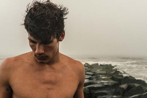person man behind sea during daytime human